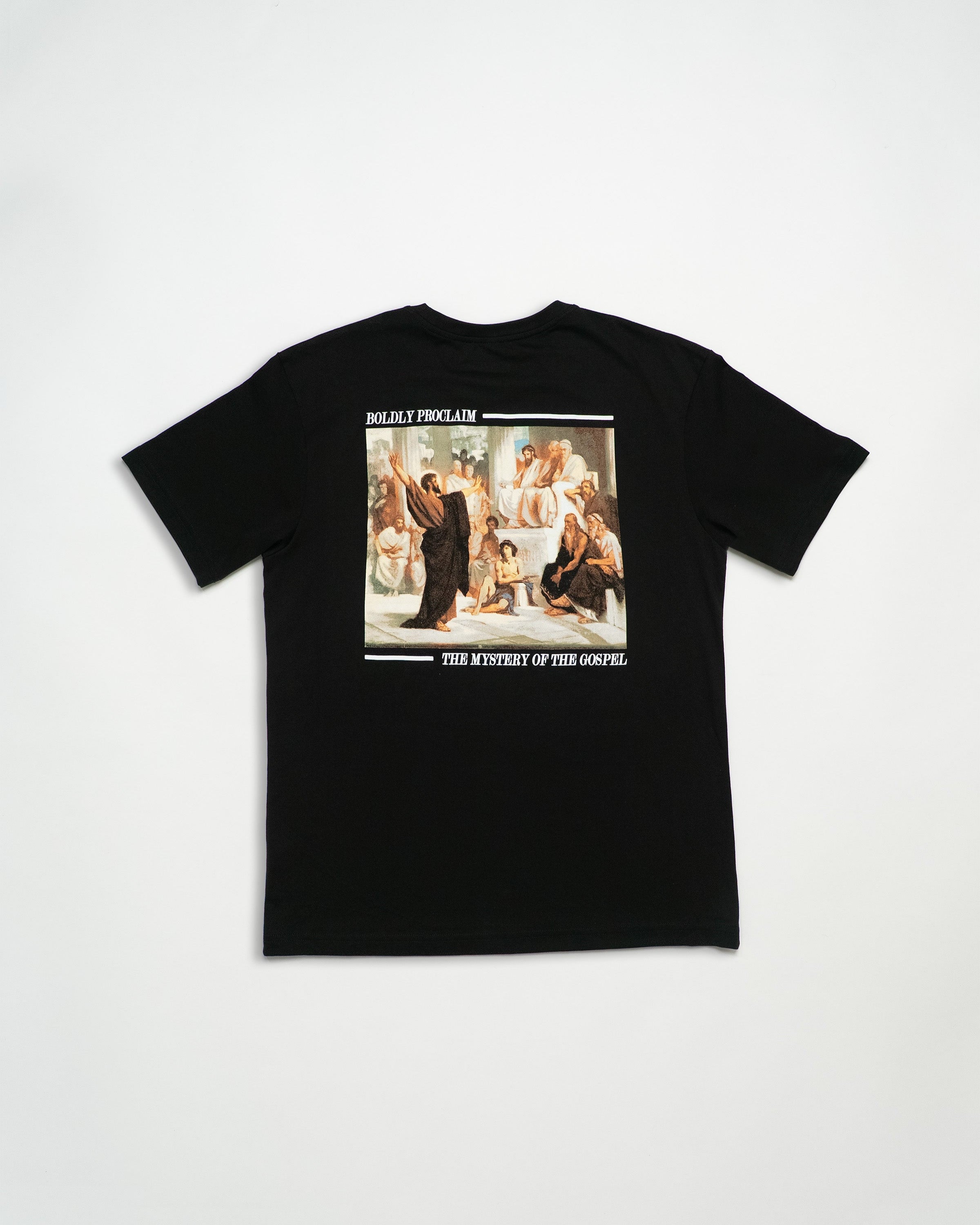 Black Christian t-shirt with art design and white lettering saying 'Boldly proclaim the mystery of the gospel.'